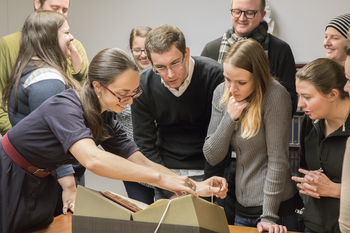 Professor Kayla Whearty and her students examine new acquisition, Postilla litteralis super epistolam ad hebraeos.