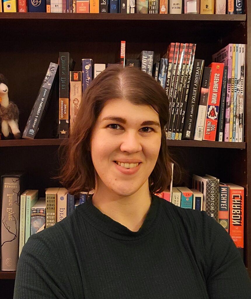 Woman with book shelf behind her