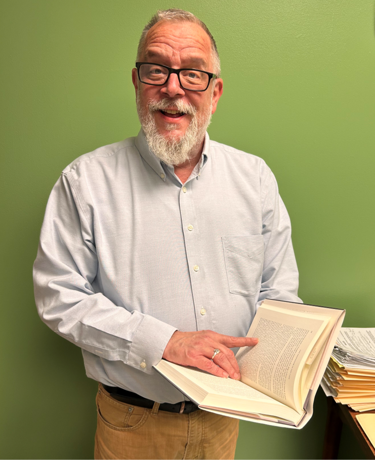 photograph of Bill Palmer, Special Collections Gift Associate, holding a book.