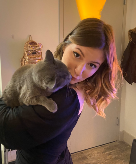photo of Binghamton student Caitlin Migliore '24 holding a cat.