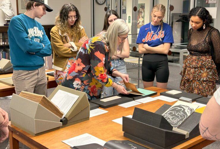 Students in ARTS 360 examine books in Special Collections