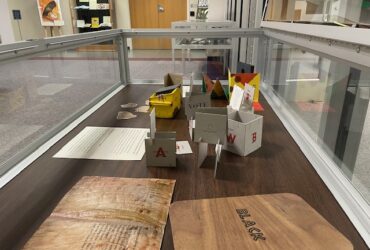 Photograph of exhibit case with book arts items on display