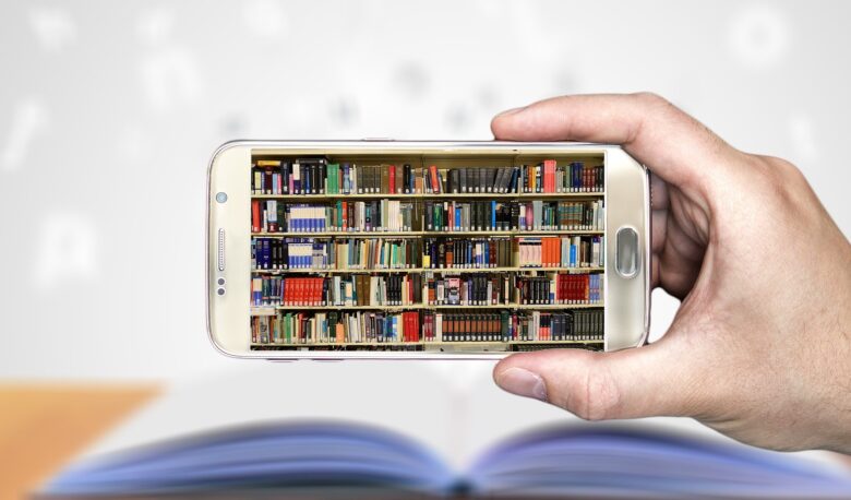 Hand holding phone with image of book shelves