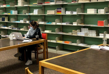 Masked student workers in a socially distanced manner in the Libraries