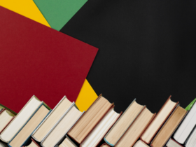 red, yellow, green, and black background with stacked books at the bottom