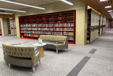 ground floor of the library featuring couch seating in front of moveable bookshelves