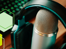 Image of a podcast recording microphone with headphones resting on top. A variety of green hexagons decorate the left side of the photo