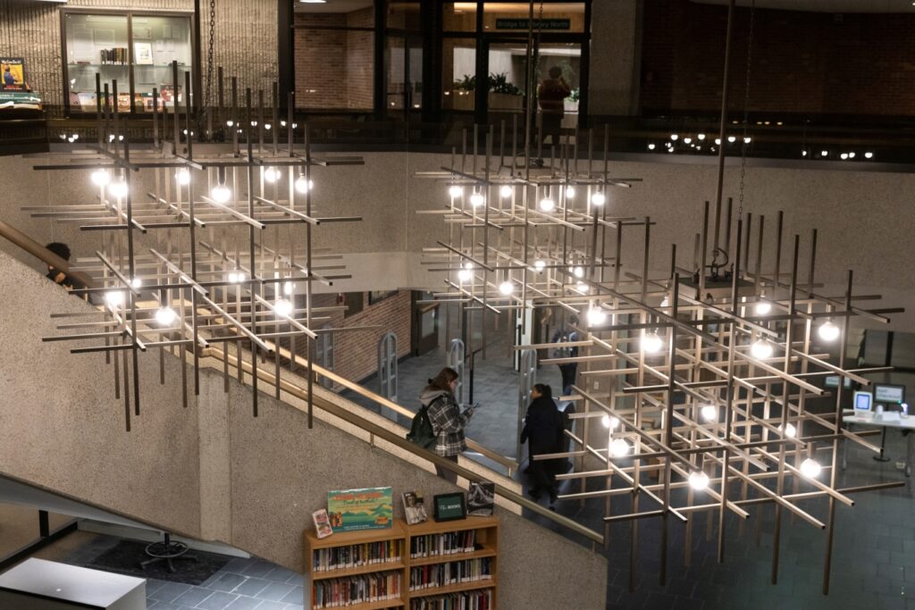 a wide-shot photo of the Bartle Library lobby with students walking down the staircase