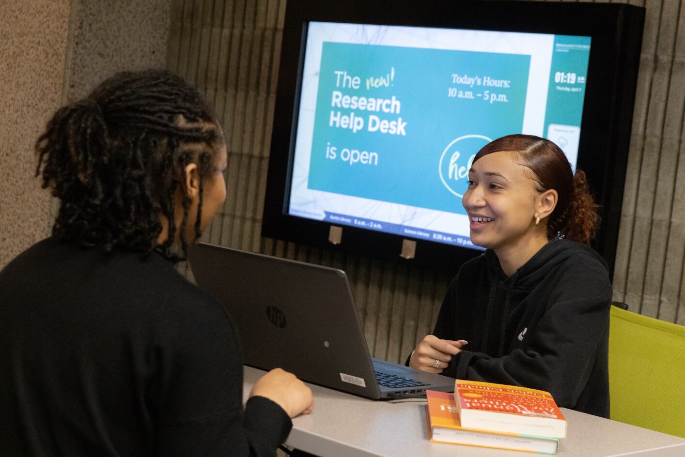 a student asks a question at the research help desk in Bartle Library