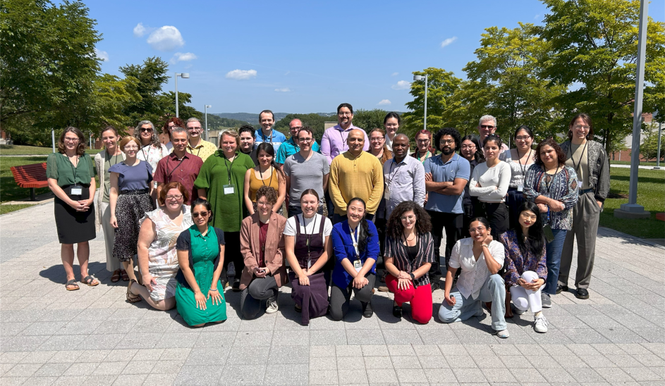 Group photo of the DHRI 2023 cohort. Various individuals standing collectively in a group outside on campus.