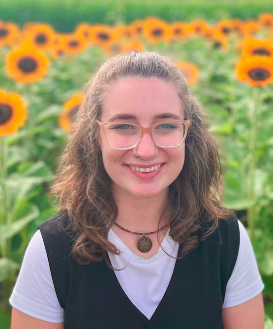 photo of Sammi Lauth in a field of sunflowers