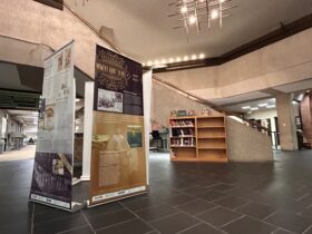 photo of the SCRLC traveling exhibit "Recognizing Women's Right to Vote in New York State" set up in the Bartle Library lobby.