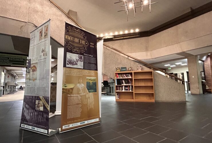 photo of the SCRLC traveling exhibit "Recognizing Women's Right to Vote in New York State" set up in the Bartle Library lobby.