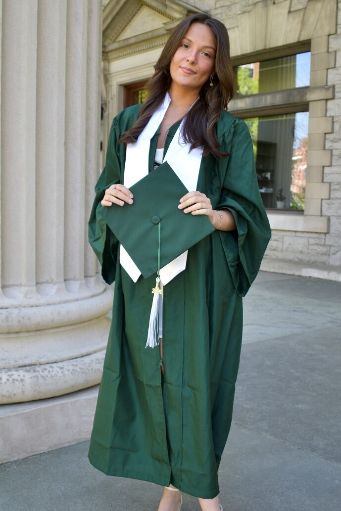 photo of Ava Cardillo in a green graduation gown.