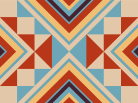 Decorative Native American inspired pattern featuring orange, blue and tan triangles of various sizes.