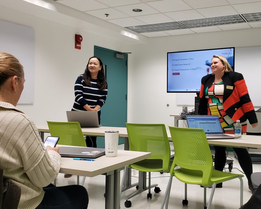 Two presenters share slides and engage with participants in the digital scholarship center.