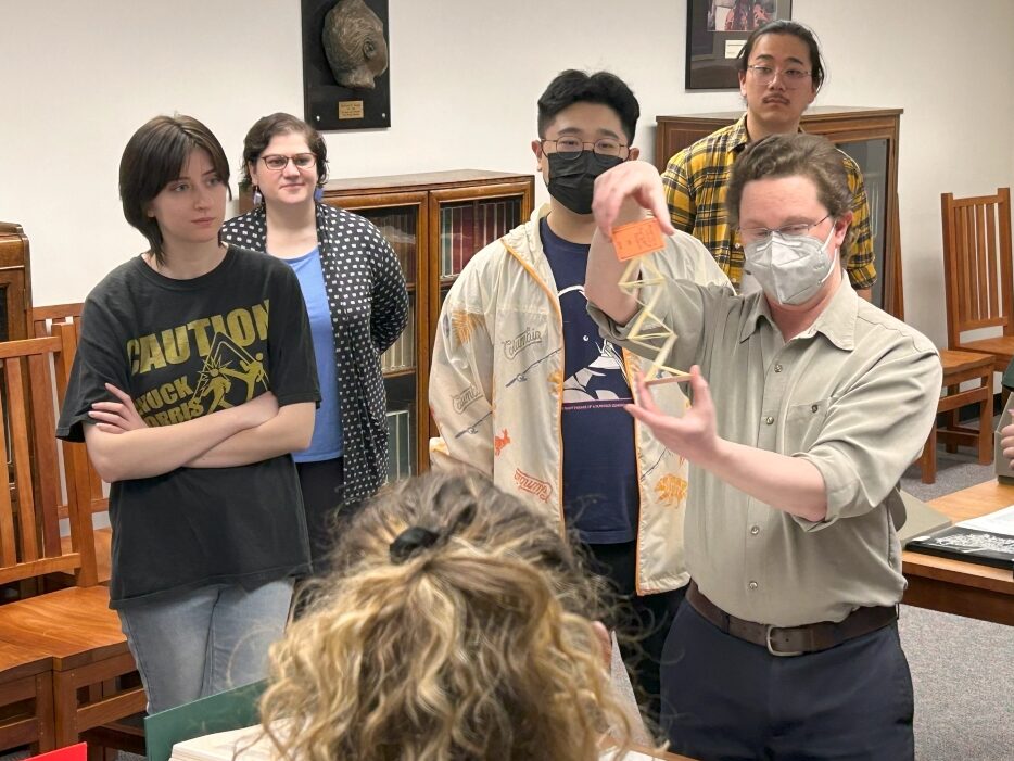 Special Collections Librarian Jeremy Dibbell shows an unconventional book to a class meeting in the Special Collections Reading Room.