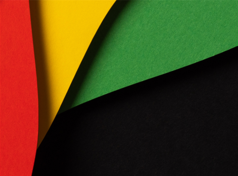 black background with decorative red, yellow and green stripes representative of Black History Month.