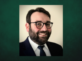 Professional Headshot of Kevin Seeber on a dark green background