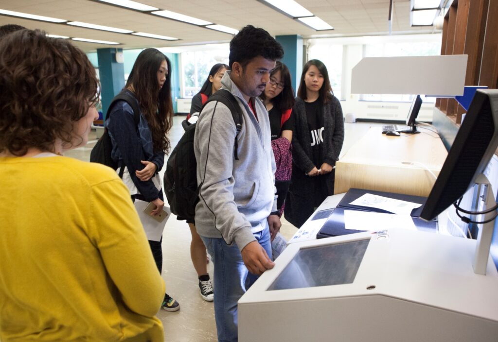 a student scans a document using a Book Eye scanner available in the Libraries