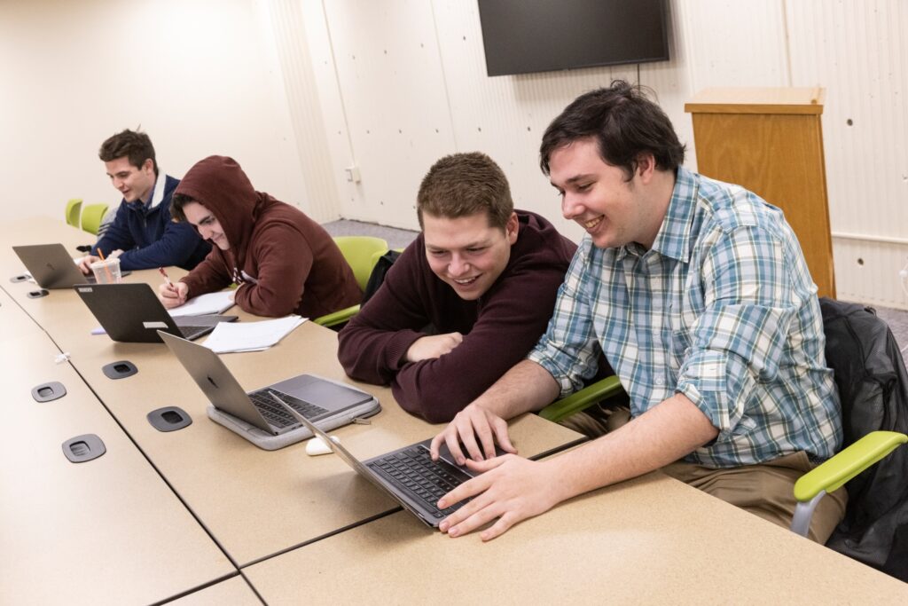 students using laptops in the Science Library group project room.