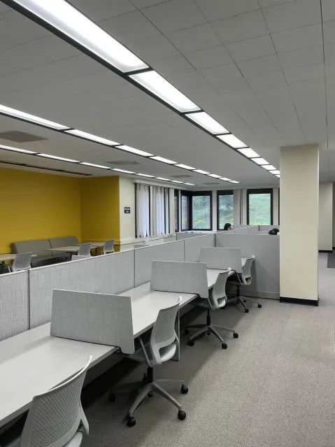 Image of the Graduate Study Commons in the Bartle Library featuring several seating options including desk cubicles and bench seating.